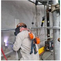 Welder working on industrial piping