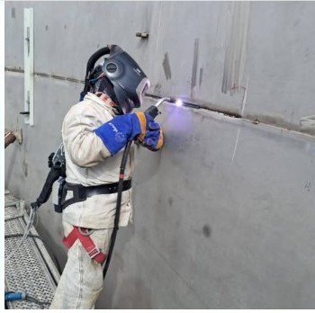 Welder performing field work on an industrial tank